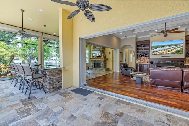 view of patio / terrace with ceiling fan and a bar