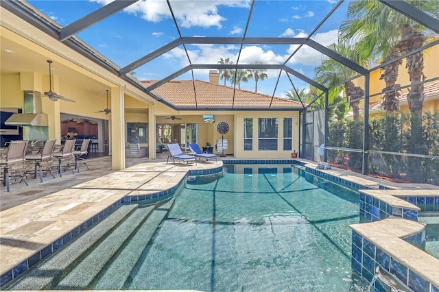 view of pool with a lanai, a patio, and ceiling fan