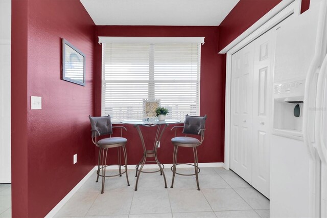 tiled dining room with a healthy amount of sunlight