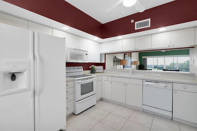 kitchen featuring white appliances, light tile patterned floors, sink, ceiling fan, and white cabinets