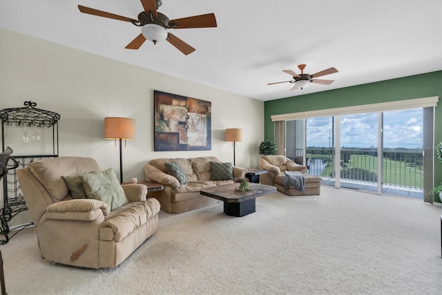 carpeted living room featuring ceiling fan