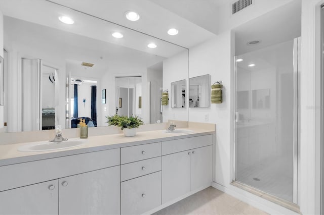 bathroom with vanity and a shower with shower door