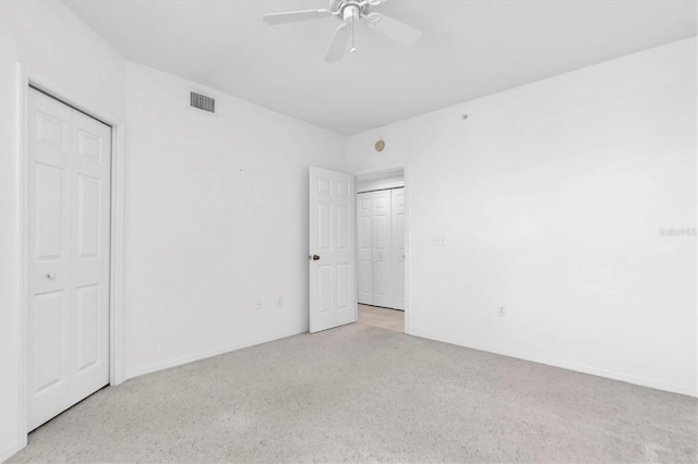 unfurnished bedroom featuring a closet, ceiling fan, and light carpet