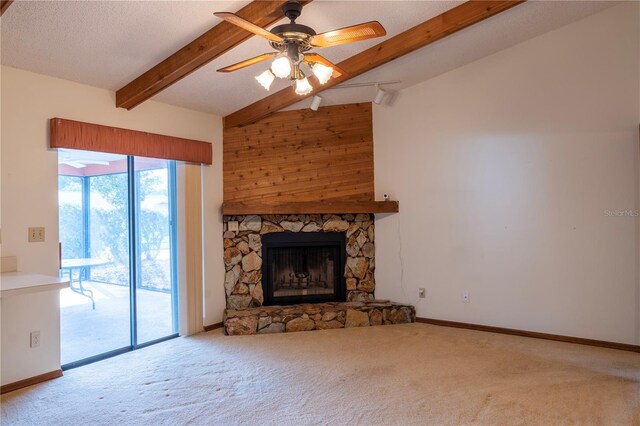 unfurnished living room featuring a textured ceiling, a fireplace, light carpet, and ceiling fan