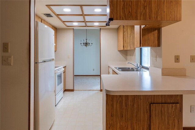 kitchen featuring white appliances, kitchen peninsula, coffered ceiling, and sink