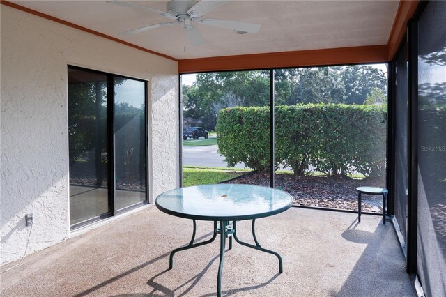 sunroom featuring ceiling fan