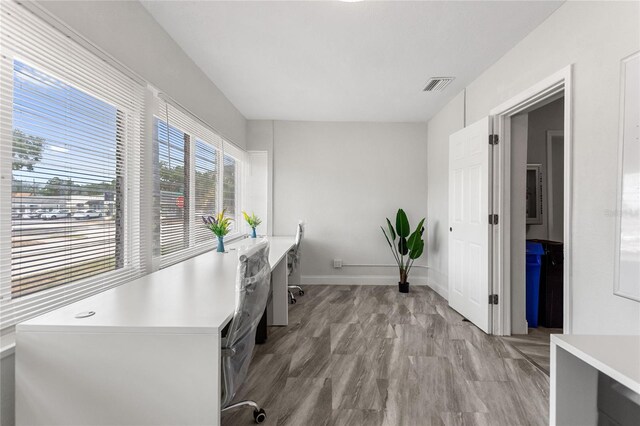 home office with light hardwood / wood-style floors