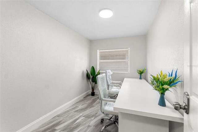 home office with light hardwood / wood-style floors