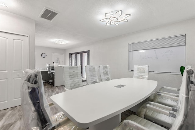 dining space with a textured ceiling