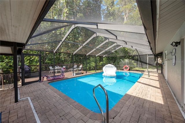 view of pool featuring a patio and glass enclosure