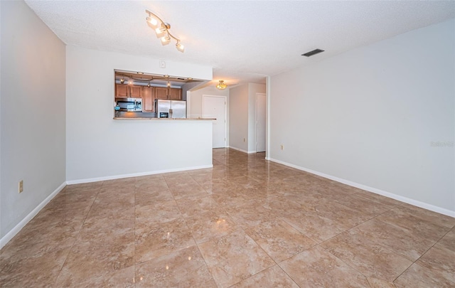 unfurnished living room with a textured ceiling