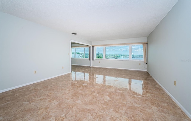 empty room with a textured ceiling