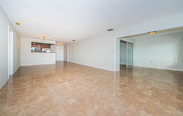 unfurnished living room featuring a textured ceiling