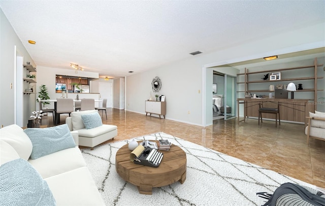 living room with a textured ceiling