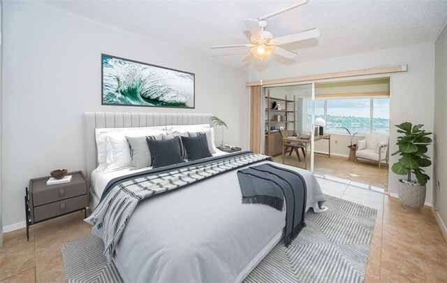 tiled bedroom featuring ceiling fan, a textured ceiling, and a closet