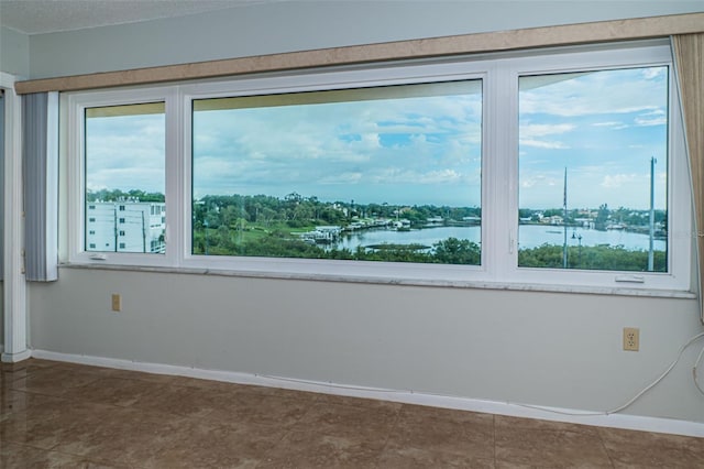 spare room with a water view and a wealth of natural light