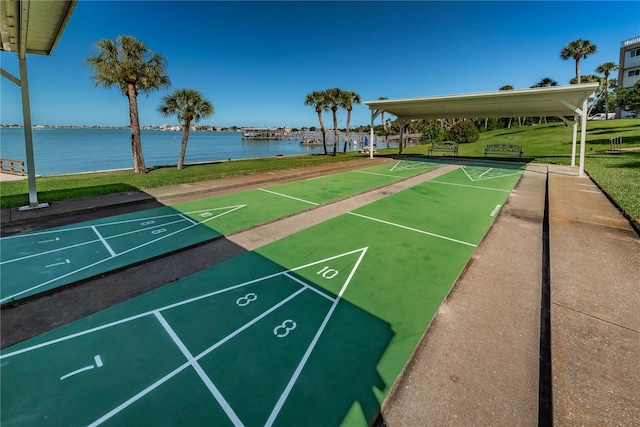 view of community featuring a water view and a lawn