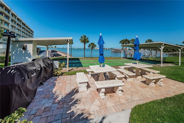 view of patio / terrace featuring a water view and a grill