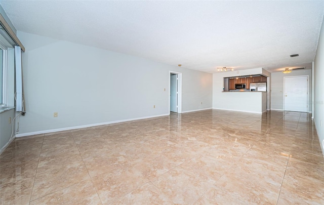 unfurnished living room with a textured ceiling