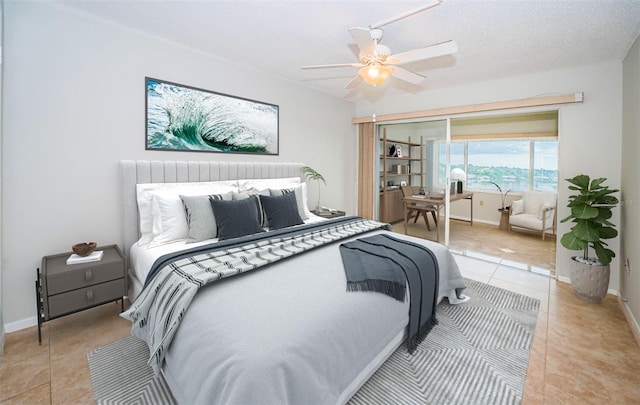 100 Bluff View Dr Unit 405C, Belleair Bluffs, FL 33770 - tiled bedroom with baseboards and ceiling fan