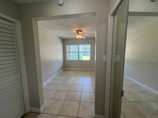 hall featuring light tile patterned floors