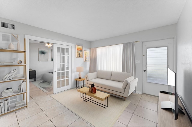 living room with light tile patterned flooring and ceiling fan