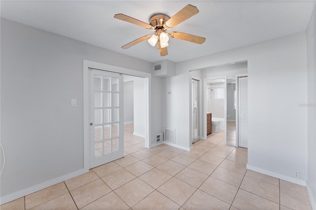 tiled empty room with ceiling fan