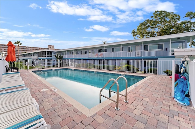 view of swimming pool featuring a patio area