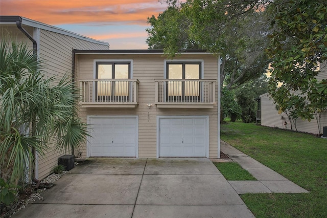 garage with driveway and central air condition unit