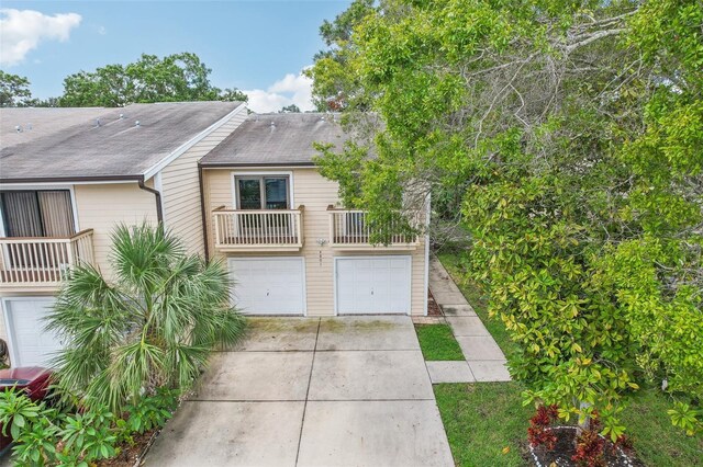 exterior space with driveway, a balcony, and a garage