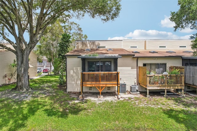 rear view of property with central AC, a yard, and a wooden deck