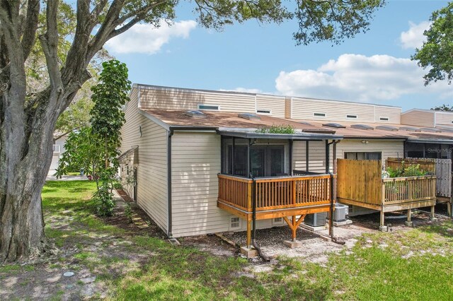 back of property featuring a deck and central AC unit