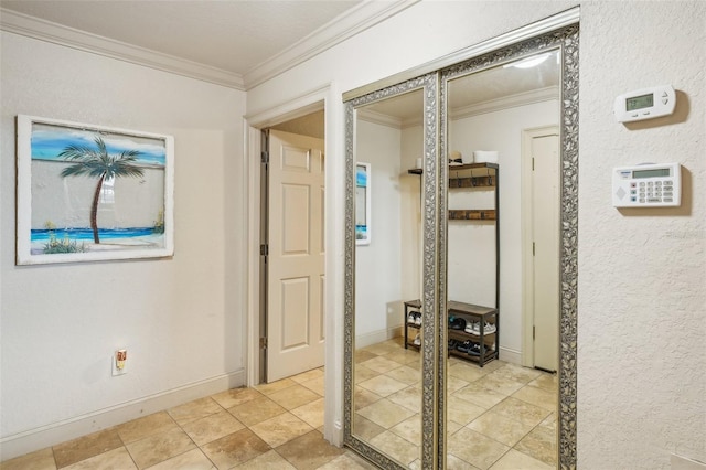 hallway with ornamental molding and baseboards