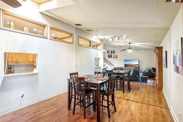 dining space featuring visible vents, stairway, a ceiling fan, wood finished floors, and baseboards