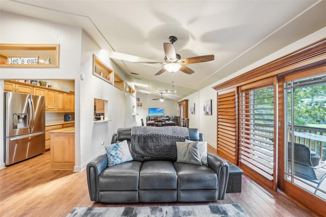 living room featuring a ceiling fan, light wood-type flooring, and baseboards