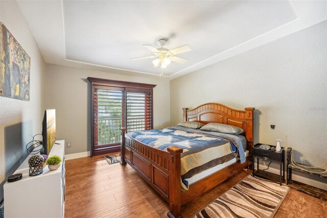 bedroom featuring baseboards, ceiling fan, and light wood-style floors