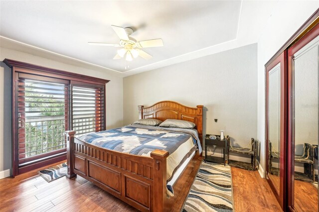 bedroom featuring ceiling fan, wood finished floors, and baseboards