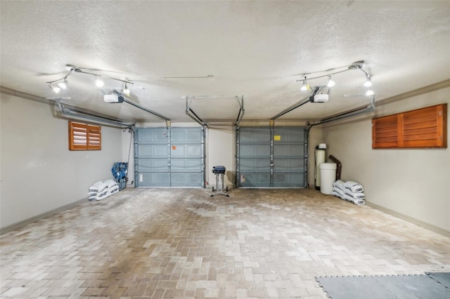 garage with baseboards and a garage door opener