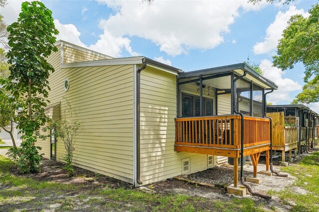 view of side of home featuring a sunroom