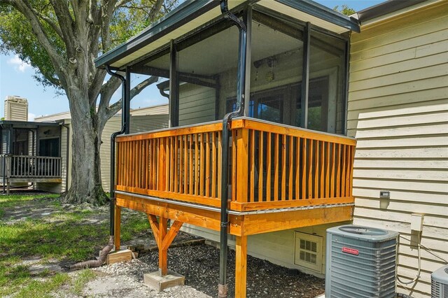 wooden deck featuring a sunroom and central AC