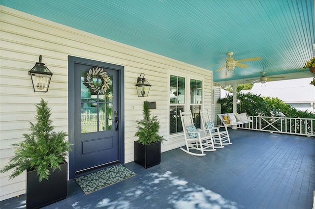 doorway to property with ceiling fan and covered porch