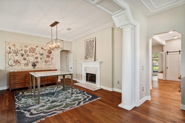 dining room featuring a notable chandelier, dark hardwood / wood-style floors, a premium fireplace, and crown molding