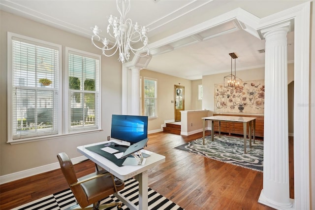 office featuring decorative columns, a wealth of natural light, a notable chandelier, and hardwood / wood-style flooring