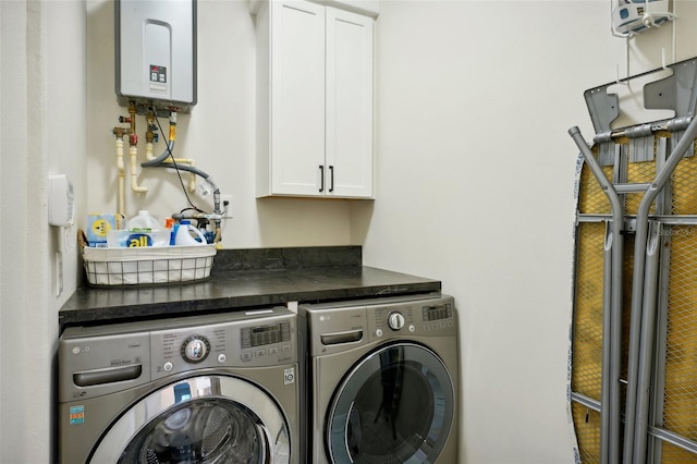 laundry area with cabinets, separate washer and dryer, and water heater