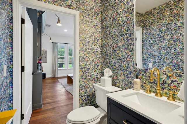 bathroom featuring hardwood / wood-style flooring, vanity, and toilet