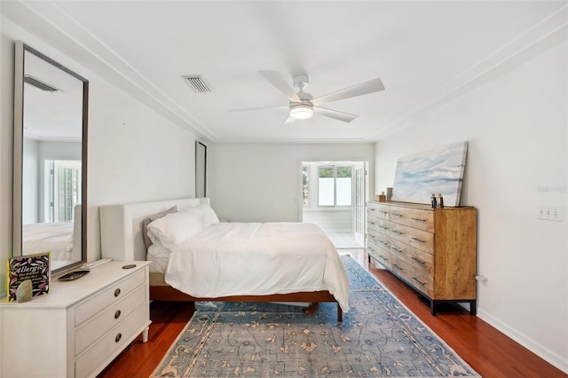 bedroom with ceiling fan and dark wood-type flooring