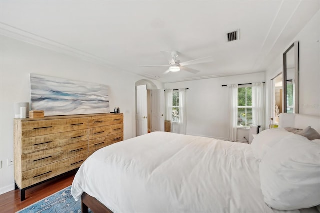 bedroom featuring dark hardwood / wood-style floors, ceiling fan, and ornamental molding