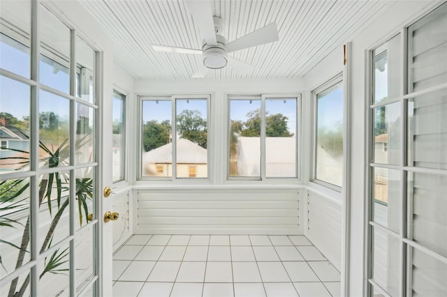 unfurnished sunroom featuring ceiling fan