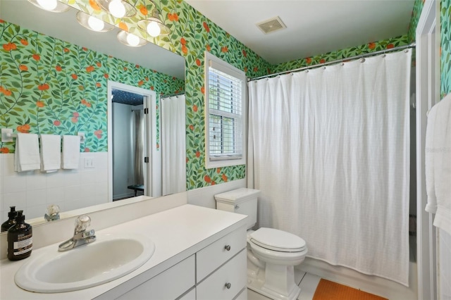 full bathroom with tile patterned floors, vanity, shower / bath combo, and toilet