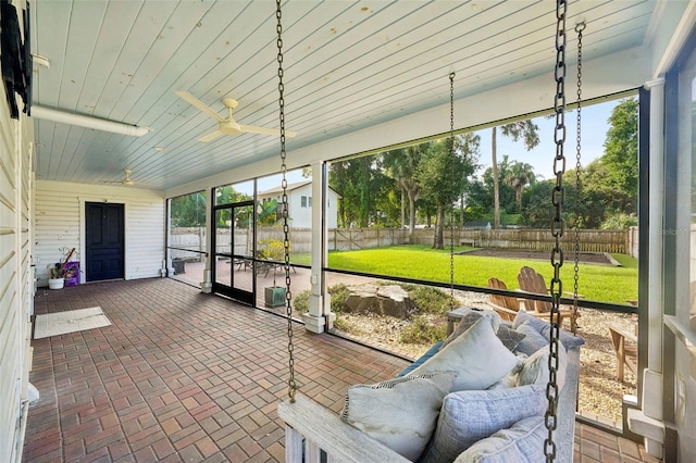 sunroom / solarium featuring ceiling fan and wood ceiling